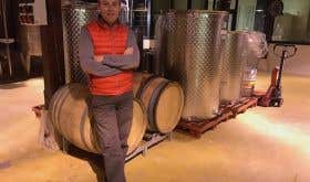 Benjamin Leroux beside burgundy barrels