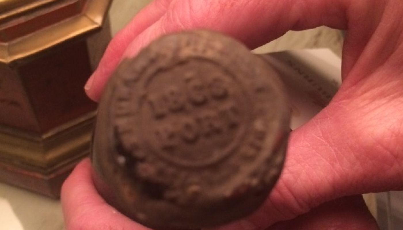 hands of Paul Symington holding 1868 port
