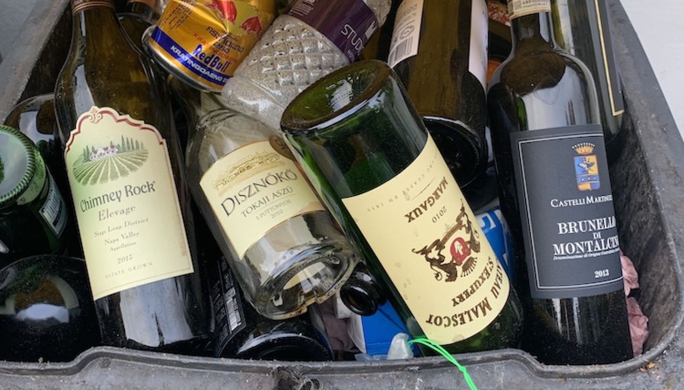 Empty wine bottles in a recycling bin