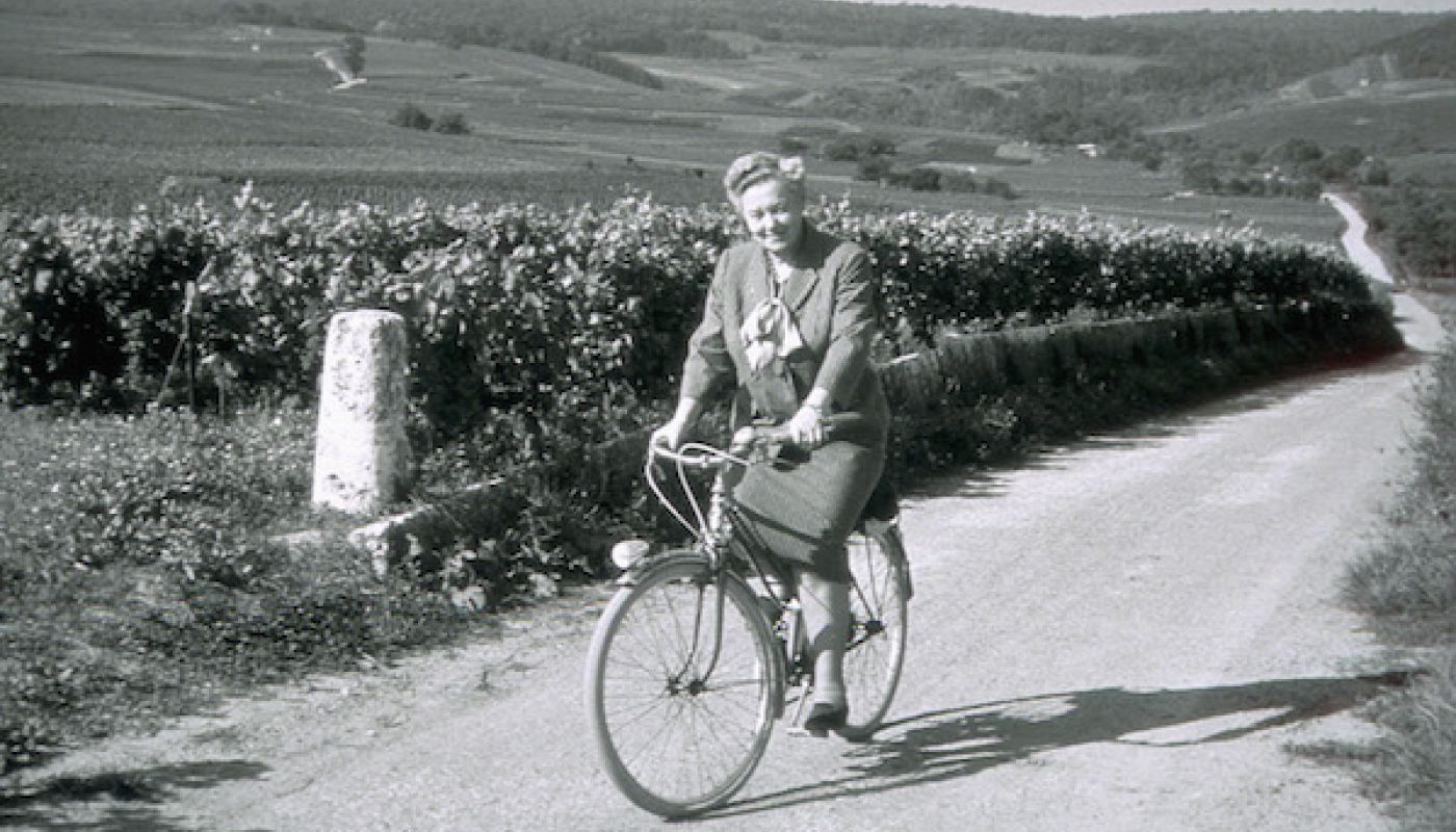 Madame Lily Bollinger on a bike in the vineyards