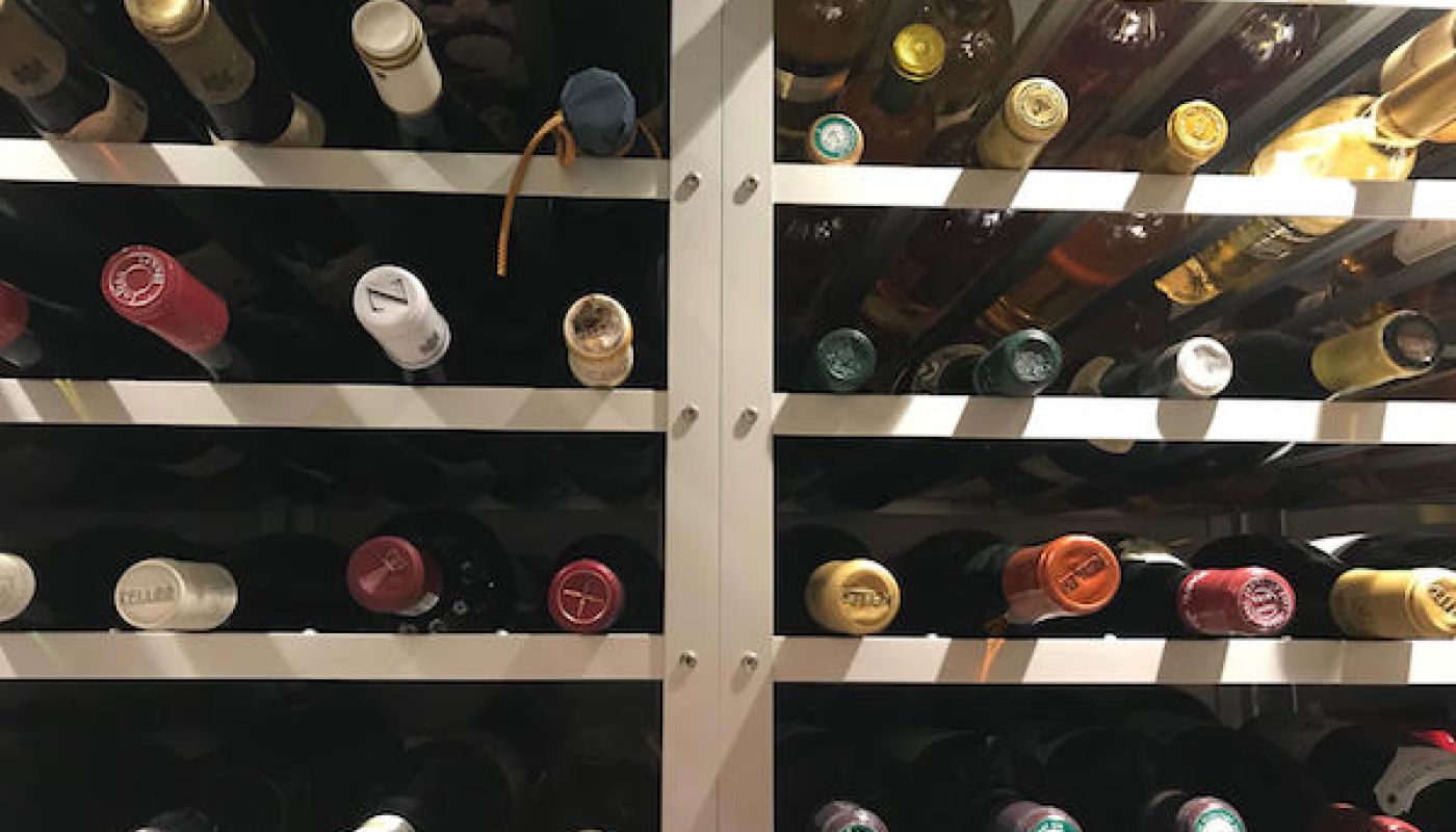 Bottles of wine on racks in a cellar