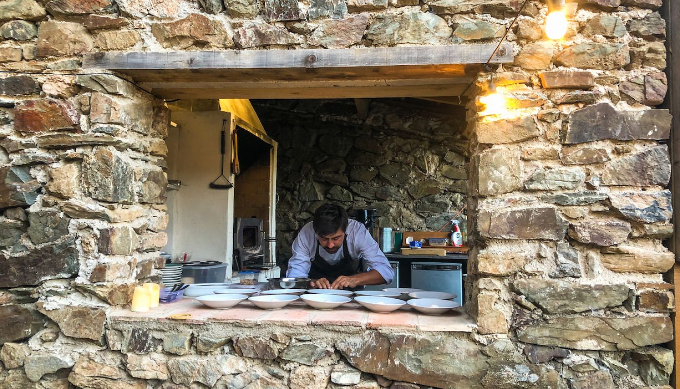 Chef Nico plating up at Dom du Meteore restaurant in a crater