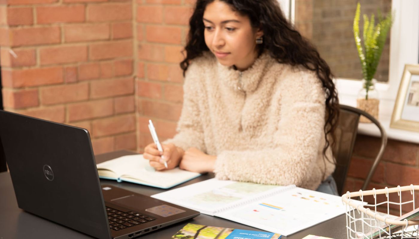 WSET student with pen and laptop