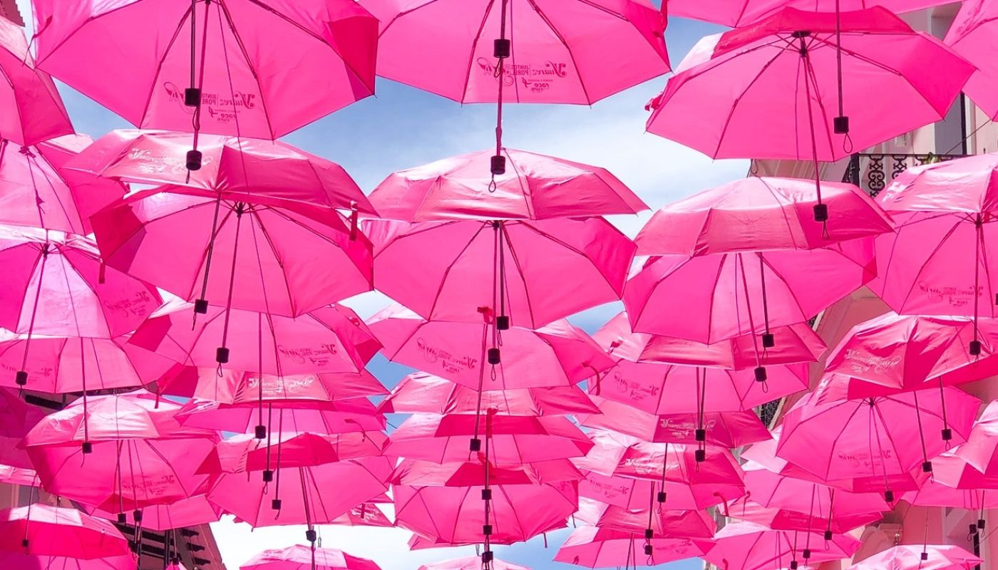 Pink umbrellas by chandler-walters-qFuKzUleXsw-unsplash