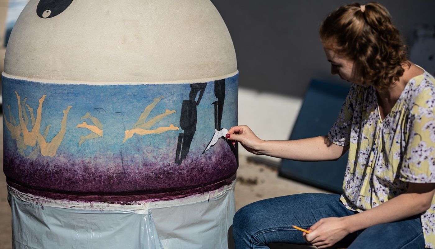 Zoli Heimann's clay eggs getting painted by a local artist