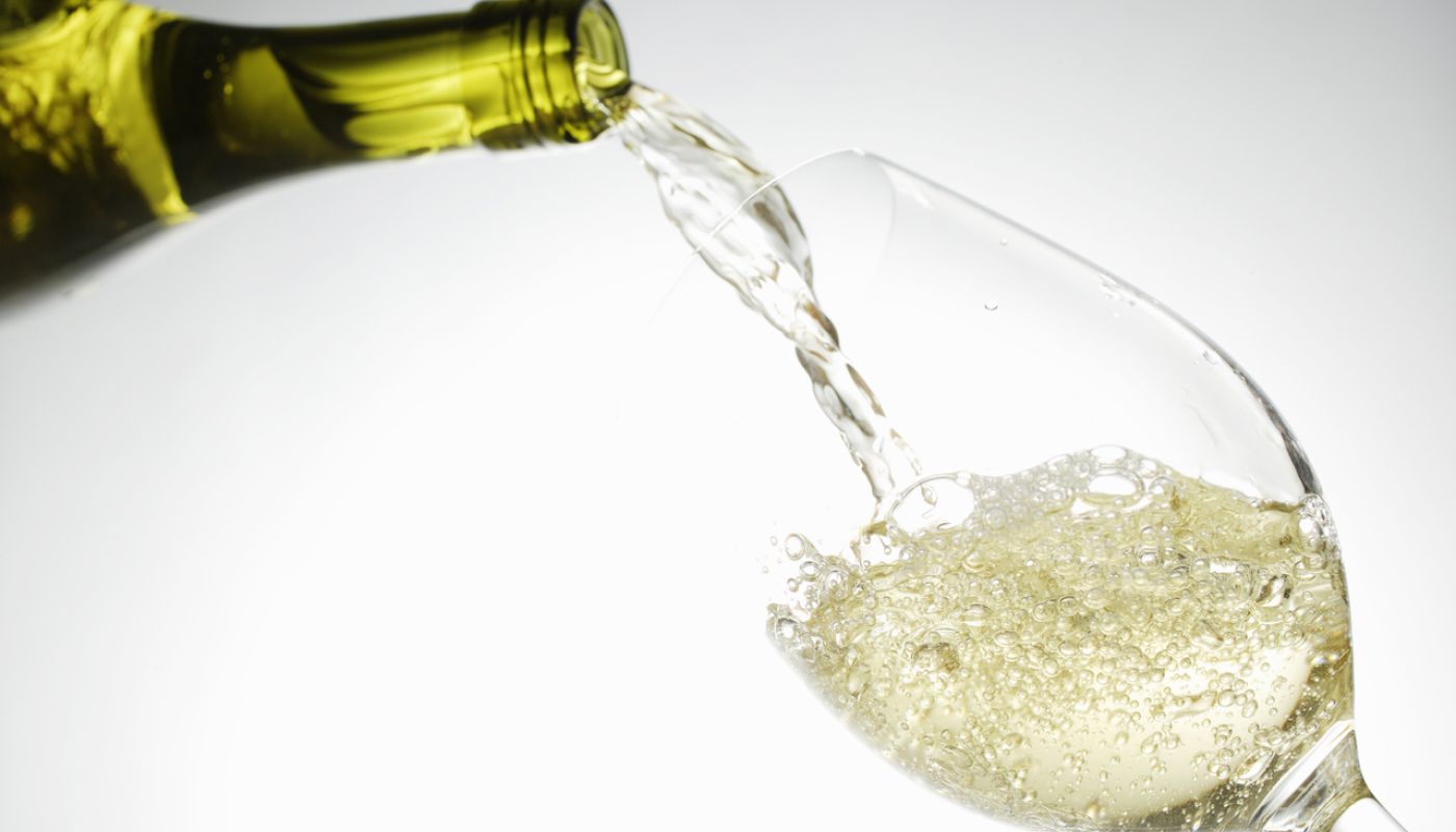 White wine being poured into a glass