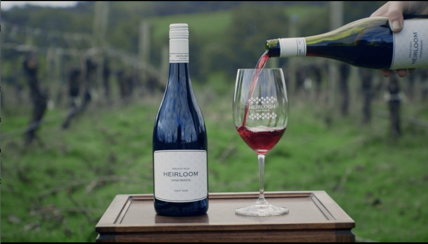 Bottle of Heirloom Pinot Noir with wine glass