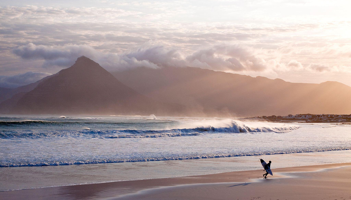 A surfer on the beach in South Africa