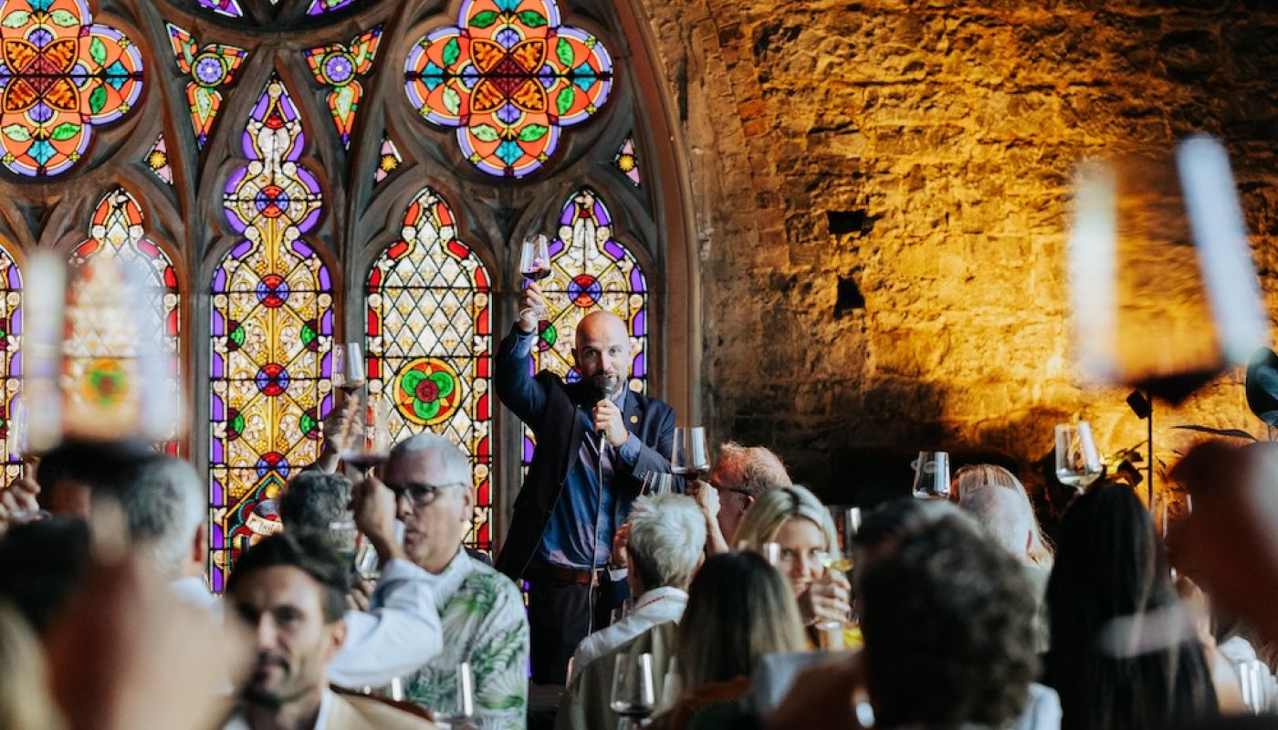 Richard Hemming raising his glass at a wine tasting