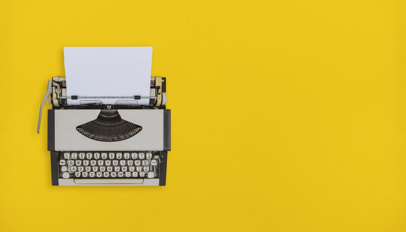 typewriter on yellow background
