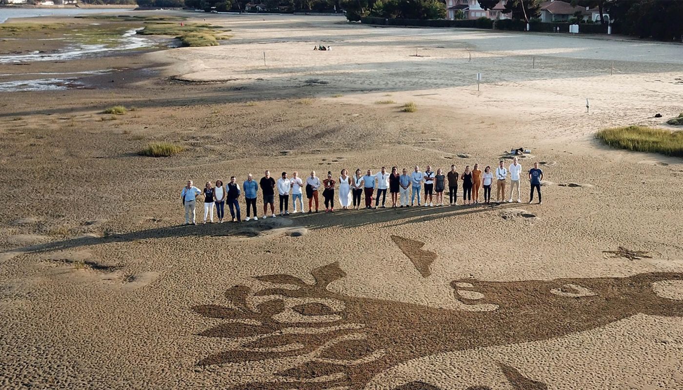 Osmin crew standing on the beach
