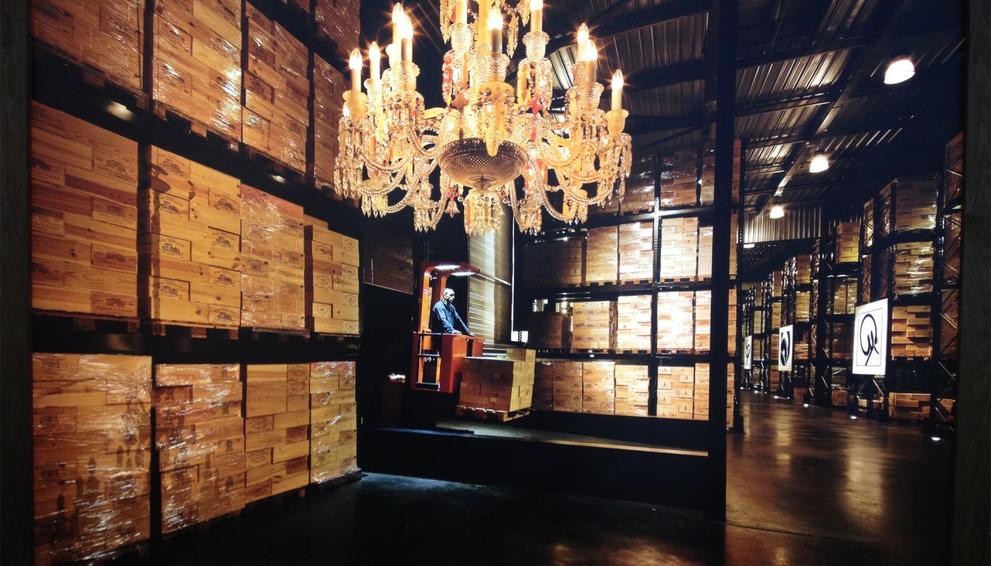 A forklift driver moves crates of wine around a Bordeaux cellar