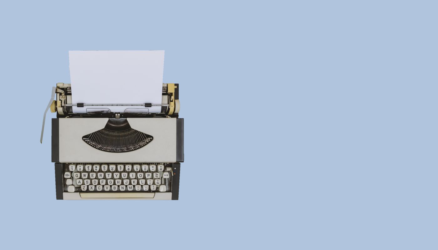Typewriter on light blue background. Image by Constantine Johnny via Getty Images.