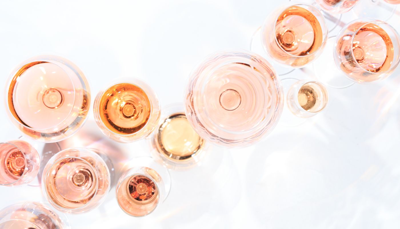 Many glasses of rose wine at wine tasting, seen from overhead