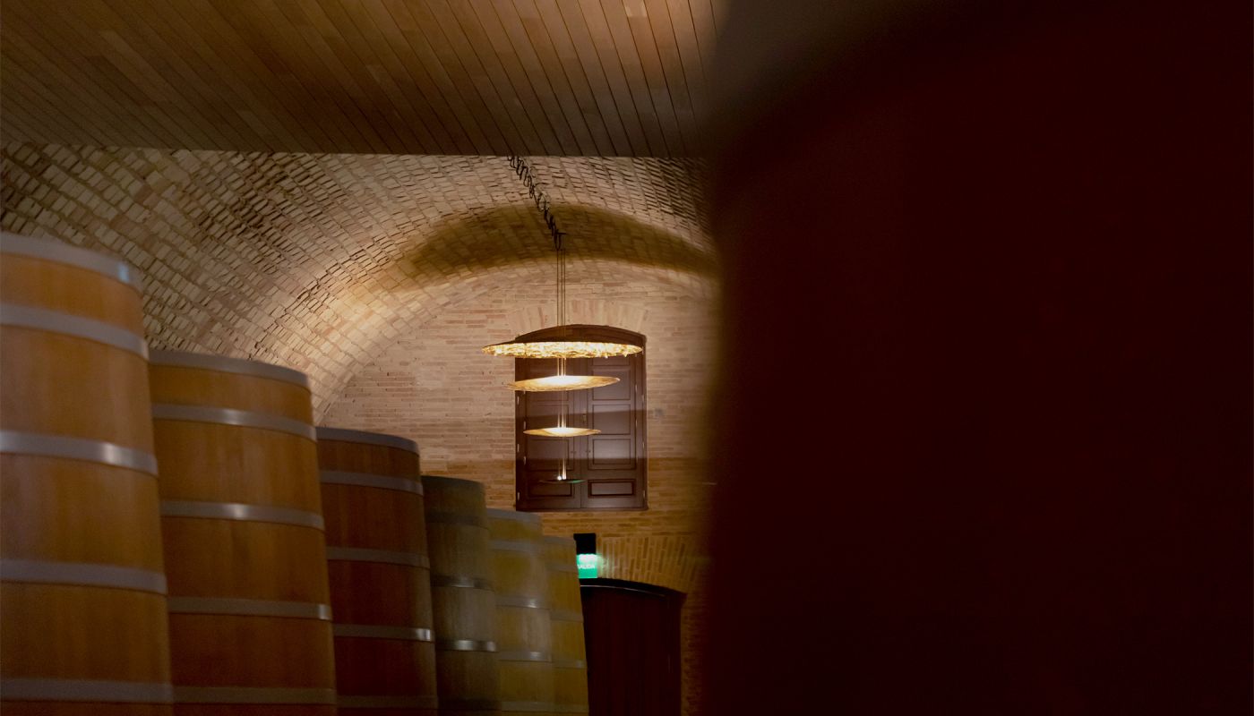 Barrels under the vaulted ceiling of Vega Sicilia's cellar