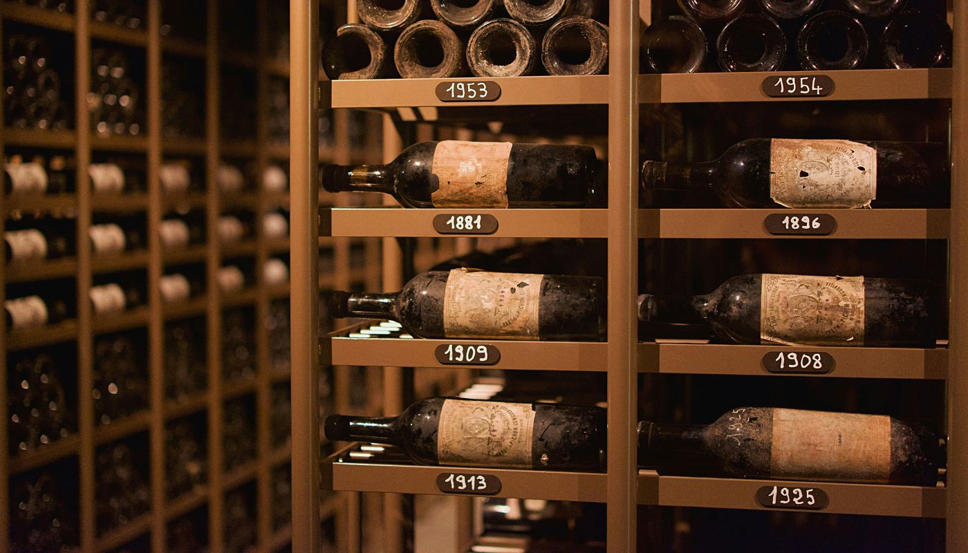 very old bottles of bordeaux in cellar