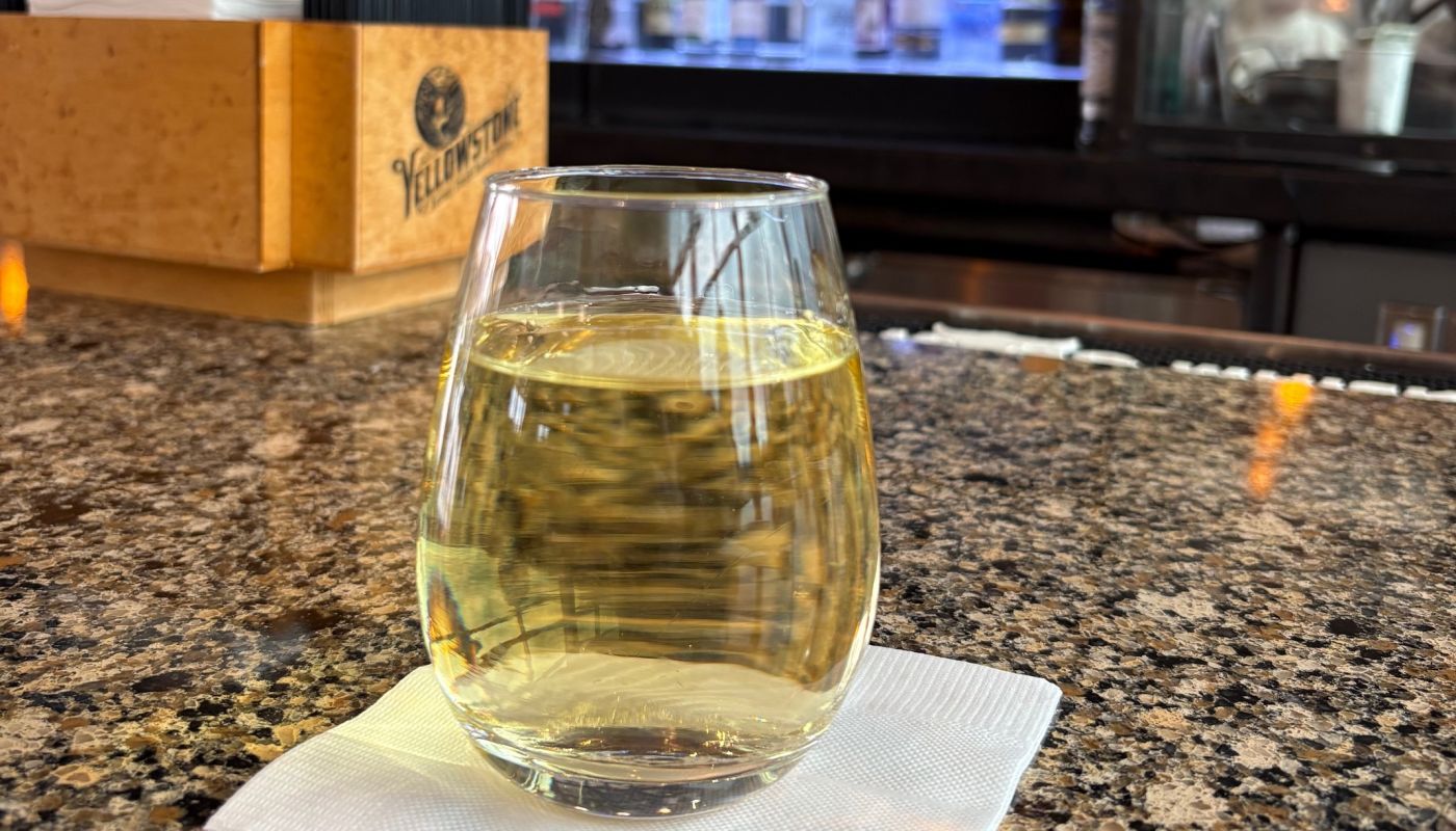 A glass of Sauvignon Blanc at an airport bar