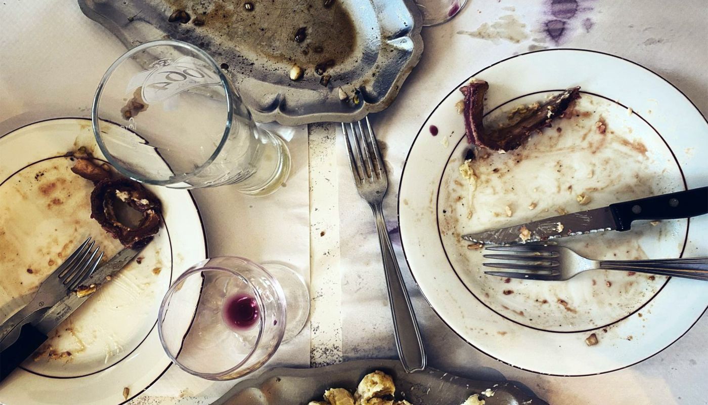 Emptied plates and glasses after a meal by Jason Lowe