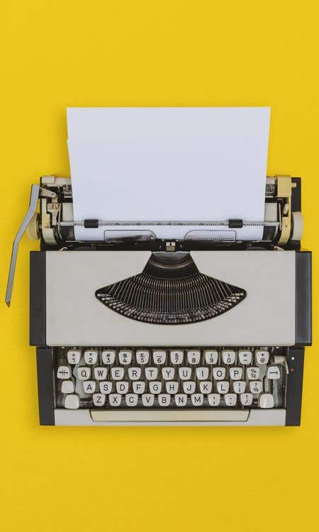typewriter on yellow background_portrait format