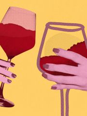 female urban hands each holding a glass of wine - Shutterstock