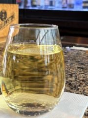A glass of Sauvignon Blanc at an airport bar