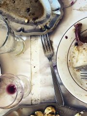 Emptied plates and glasses after a meal by Jason Lowe