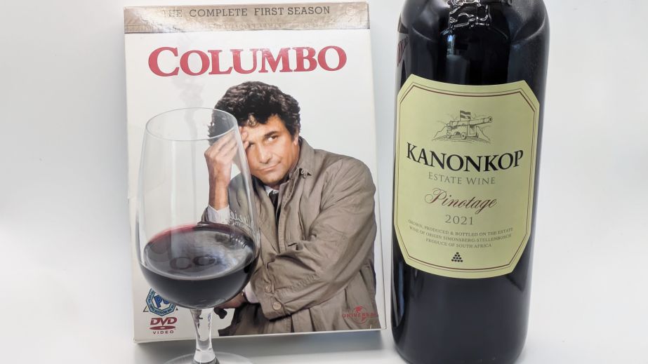 Caption: A Columbo DVD box set with a bottle and glass of Kanonkop Pinotage