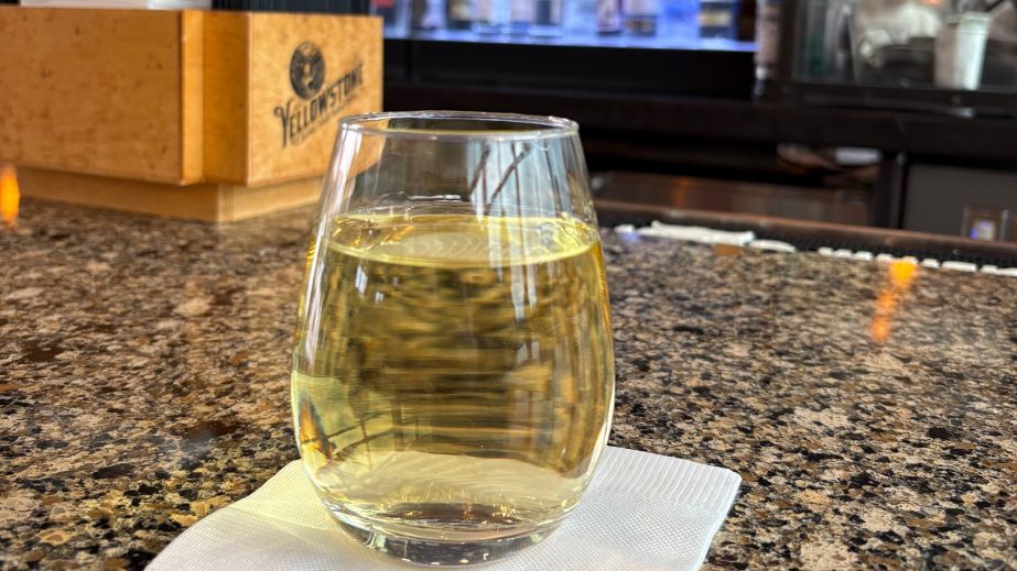 A glass of Sauvignon Blanc at an airport bar