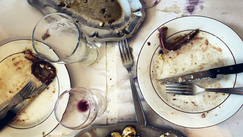 Emptied plates and glasses after a meal by Jason Lowe