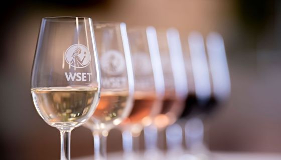 Wine in glasses embossed with the logo of the Wine & Spirit Education Trust