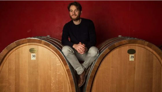 Diego Conterno sits on large botti in his cellar