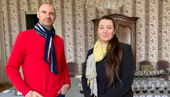 Nicolas Sinoquet & Virginie Sallette of Ch Gruaud-Larose in Bordeaux stand in front of a table of glasses, ready for a vertical tasting of their wine.
