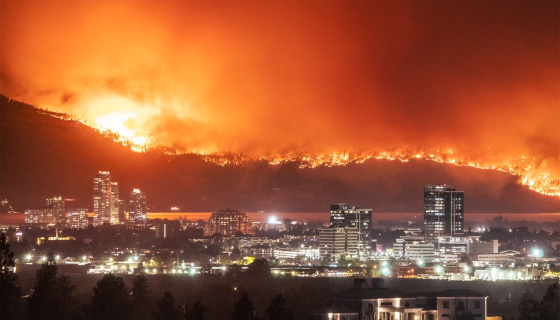 Looking across Kelowna's city downtown on August 18, across Okanagan Lake to the hills of West Kelowna, which are in flames. 