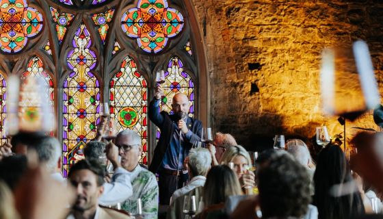 Richard Hemming raising his glass at a wine tasting