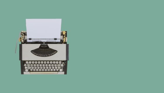 typewriter on sea green Background