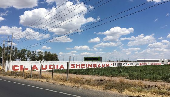 Claudia Sheinbaum Presidente graffiti painted on a wall off the highway in Mexico