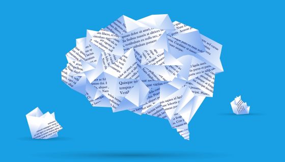 A brain filled with words on pieces of paper by Moor Studio via iStock