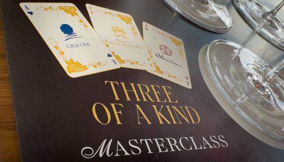 Wine tasting mat saying 'three of a kind' with wine glasses