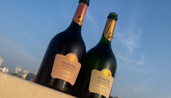 two sunlit bottles of champagne: Taittinger Comtes de Champagne 2014 and Taittinger Comtes de Chamapgne rosé 2012