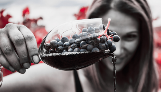 Raquel Jones in a vineyard with grapes in a wineglass