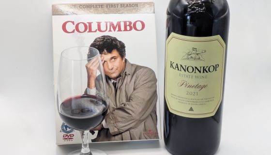 Caption: A Columbo DVD box set with a bottle and glass of Kanonkop Pinotage
