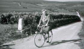 Madame Lily Bollinger on a bike in the vineyards