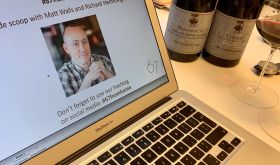 Laptop and wine bottles ready for an online wine tasting