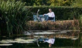 Steven Spurrier by a pond at home in Dorset
