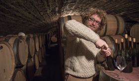 Sylvain Pataille opens bottles in his cellar