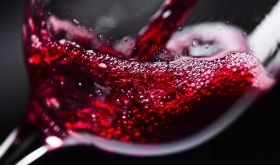 Generic red wine splashing into a glass