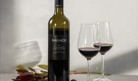 Bottle of Xanadu Cabernet with two glasses