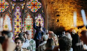 Richard Hemming raising his glass at a wine tasting