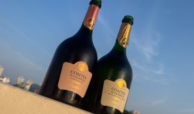 two sunlit bottles of champagne: Taittinger Comtes de Champagne 2014 and Taittinger Comtes de Chamapgne rosé 2012