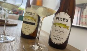 Two bottles of Pikes Riesling on a table with two partly filled wine glasses beside each bottle